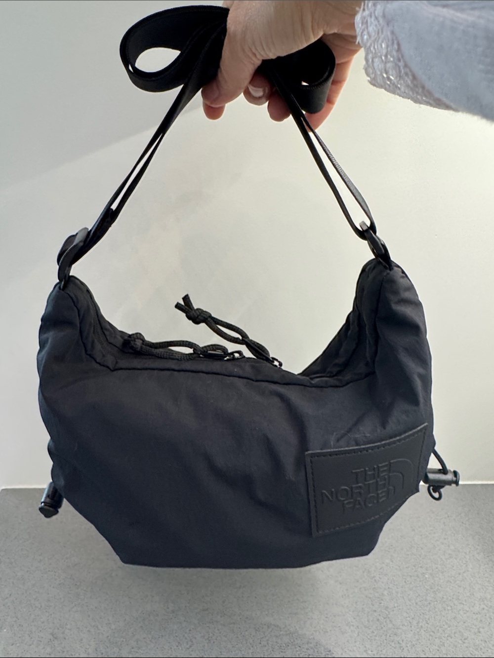 The North Face crossbody bag with Logo Patch in black color.